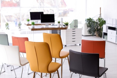 Photo of Office interior with many comfortable chairs. Business training