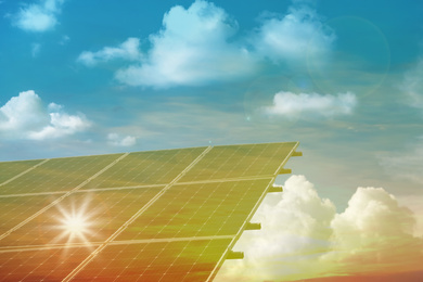 Image of Solar panels against blue sky on sunny day. Alternative energy source