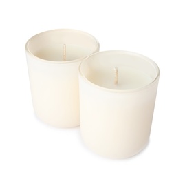 Photo of Candles in glass holders on white background