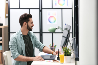 Photo of Male designer working at desk in office