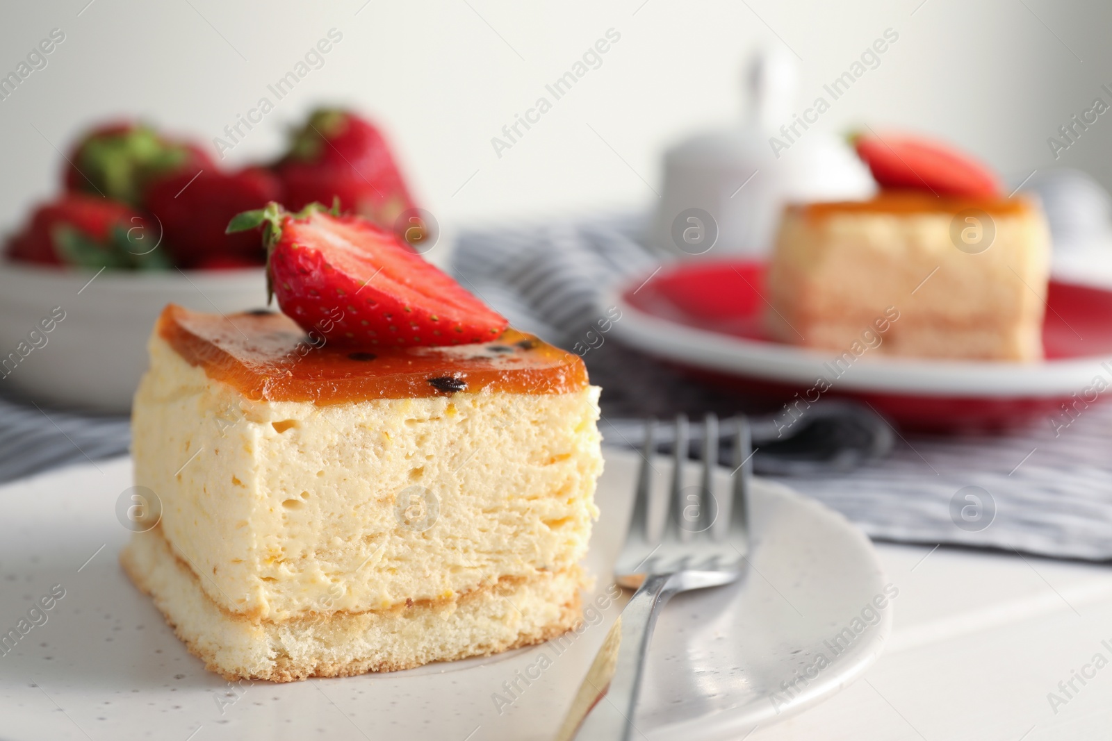 Photo of Piece of cheesecake with strawberry and fork on table, closeup with space for text
