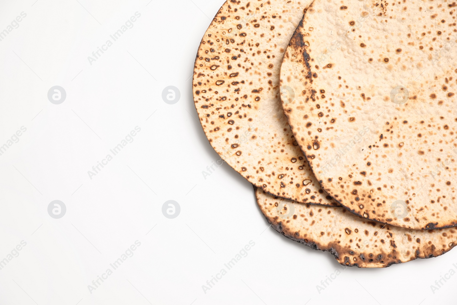 Photo of Tasty matzos on white background, top view. Passover (Pesach) celebration