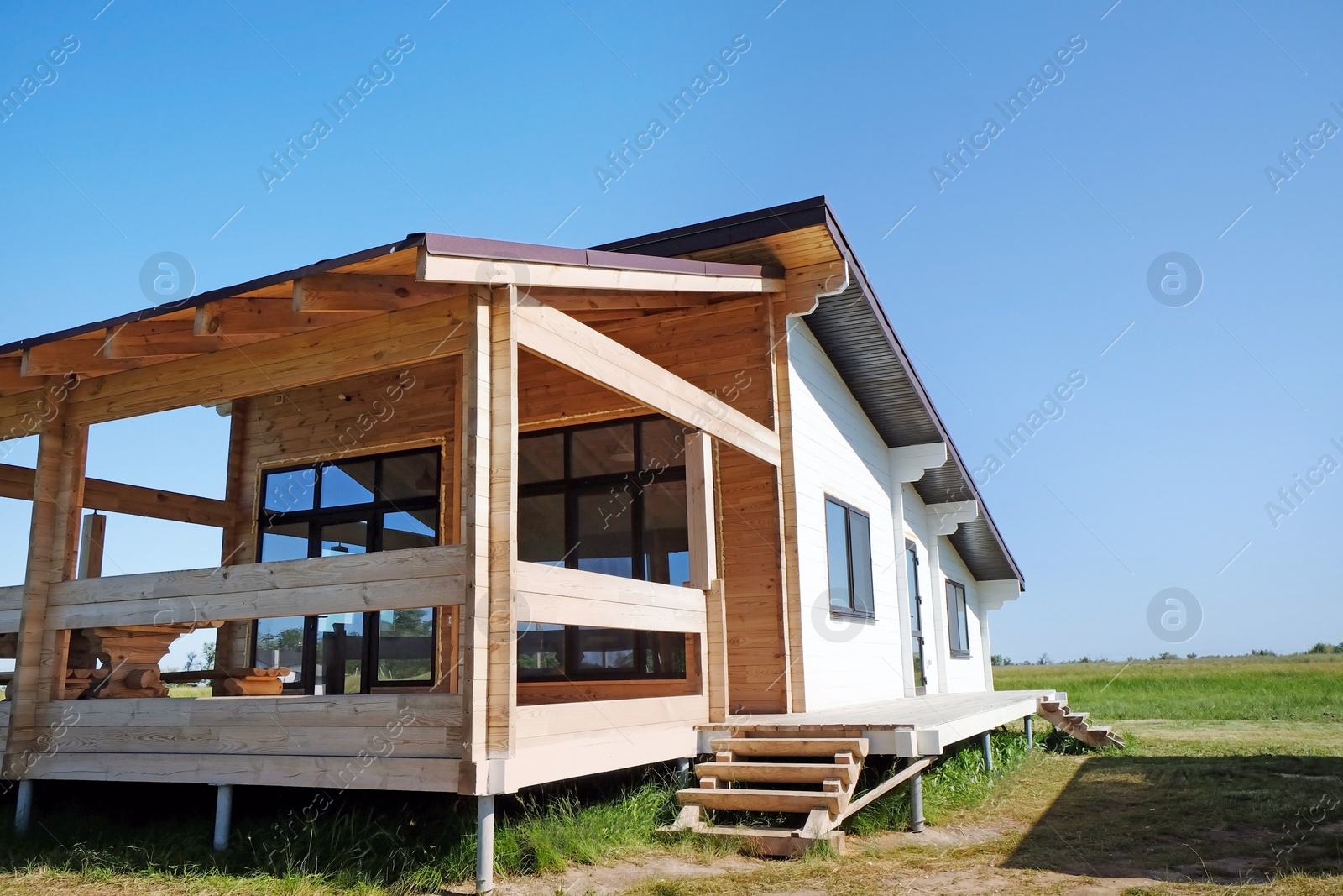 Photo of Wooden house in countryside on sunny day