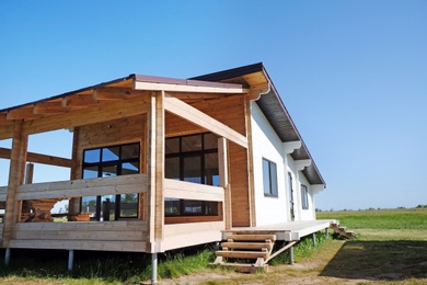 Photo of Wooden house in countryside on sunny day