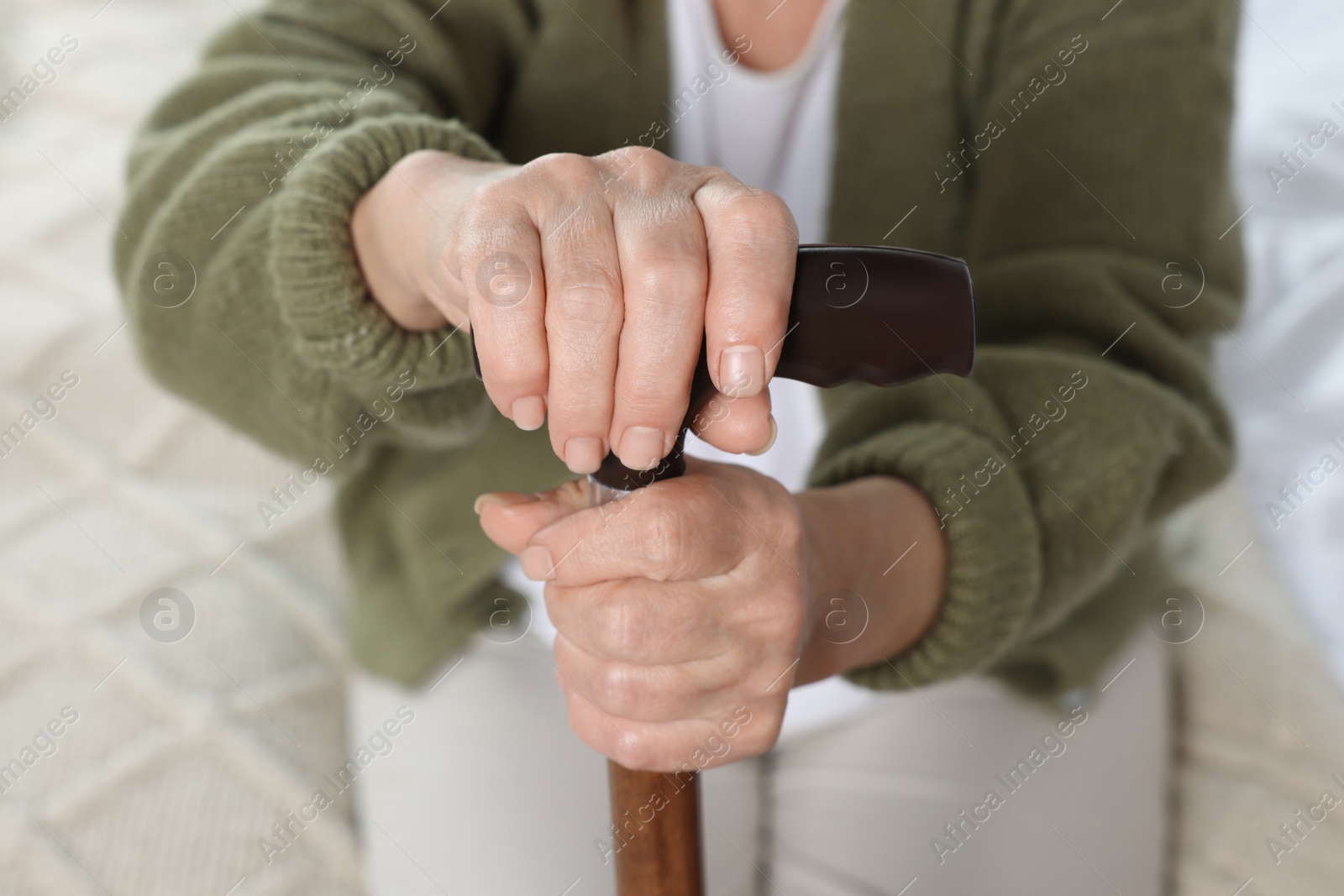 Photo of Elderly woman with walking cane indoors, closeup. Home care service