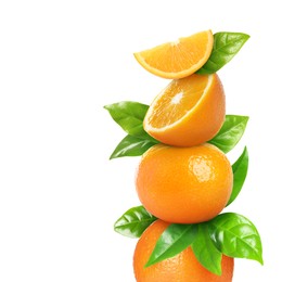 Image of Stacked cut and whole oranges with green leaves on white background