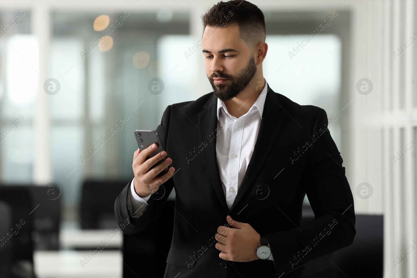 Photo of Handsome man with smartphone in office. Lawyer, businessman, accountant or manager