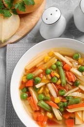 Bowl of delicious turnip soup on light table, flat lay