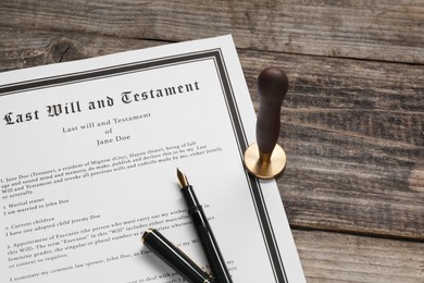 Photo of Last Will and Testament with wax stamp and fountain pen on wooden table, above view