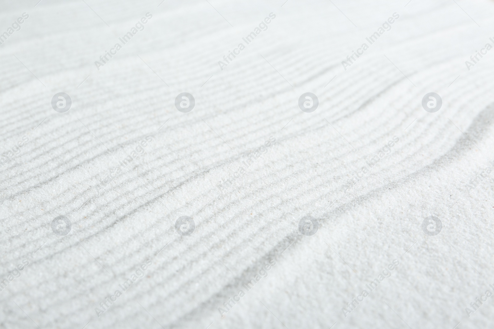 Photo of Zen rock garden. Wave pattern on white sand, closeup