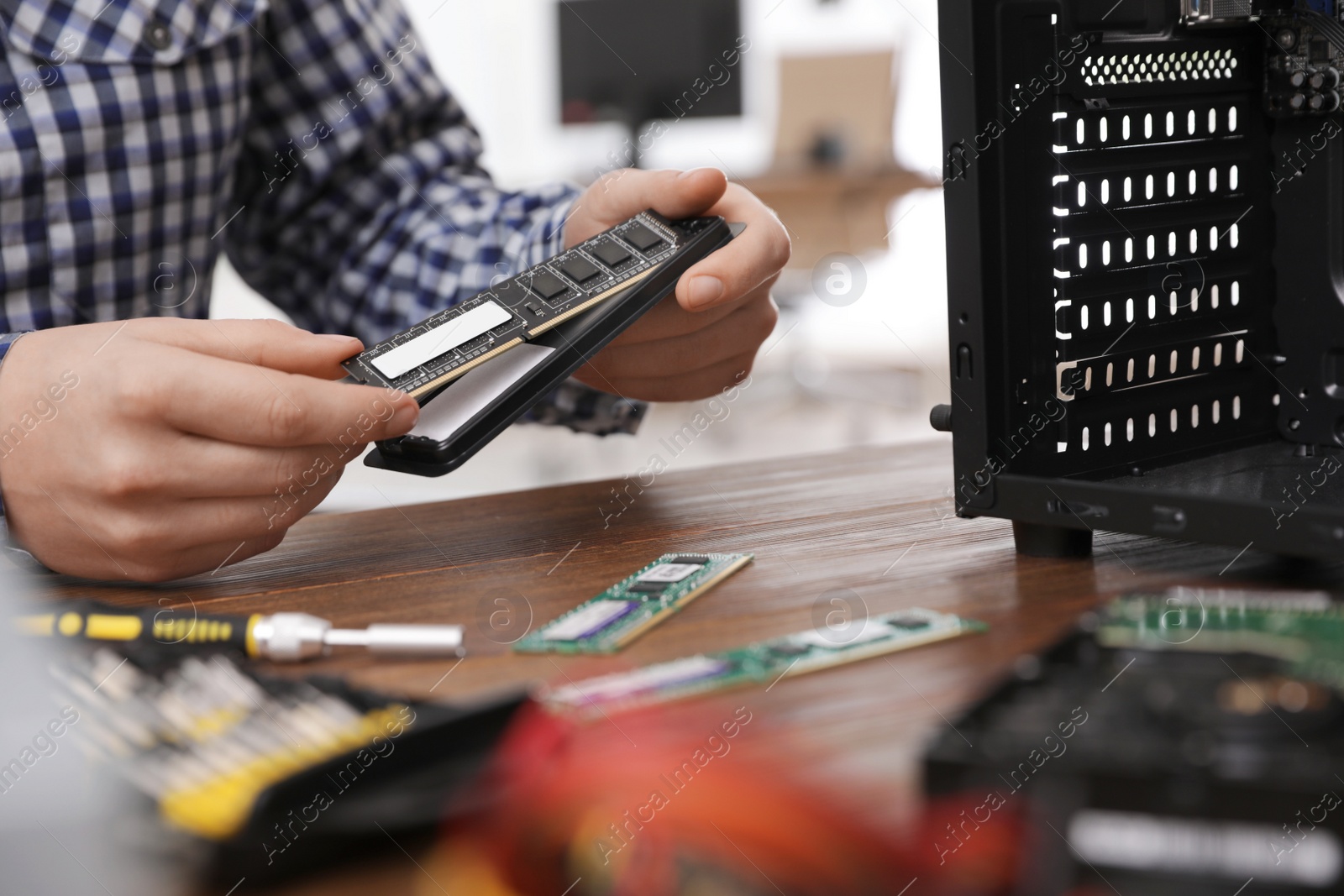 Photo of Male technician repairing computer at table, closeup