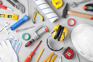 Flat lay composition with construction tools on light grey background