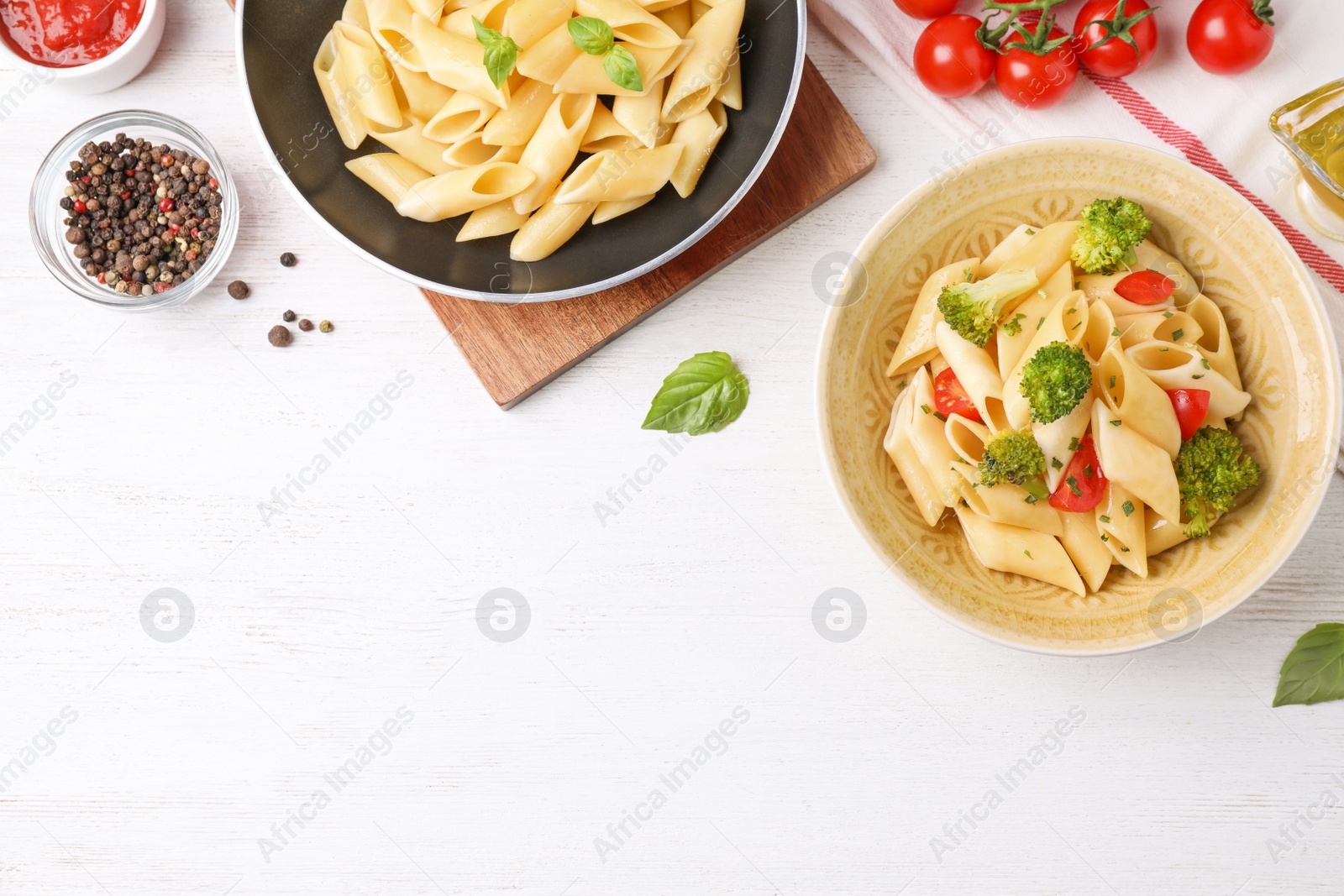 Photo of Flat lay composition with tasty pasta on white wooden table, space for text