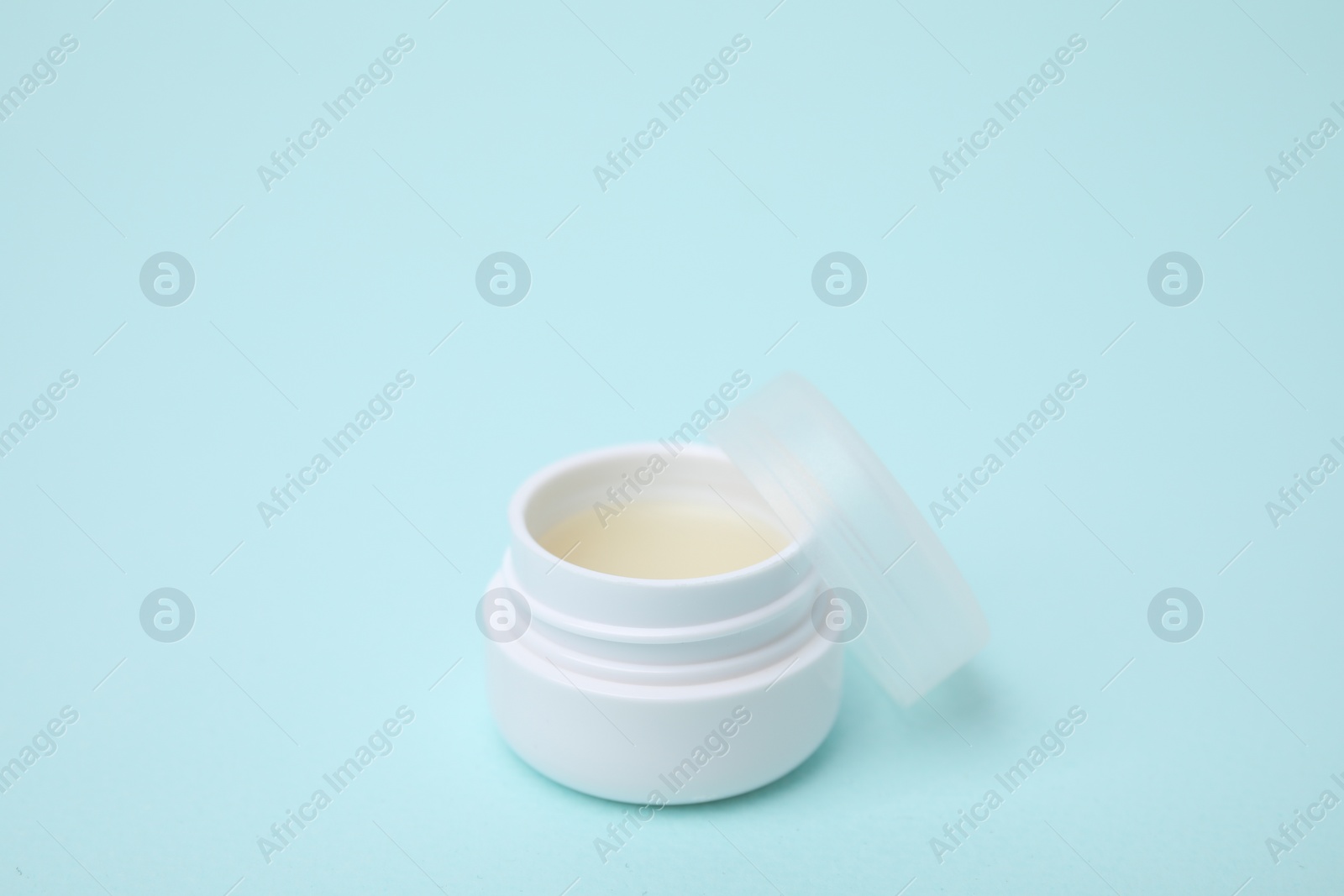 Photo of Jar of petroleum jelly on light blue background