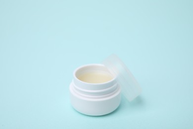 Jar of petroleum jelly on light blue background