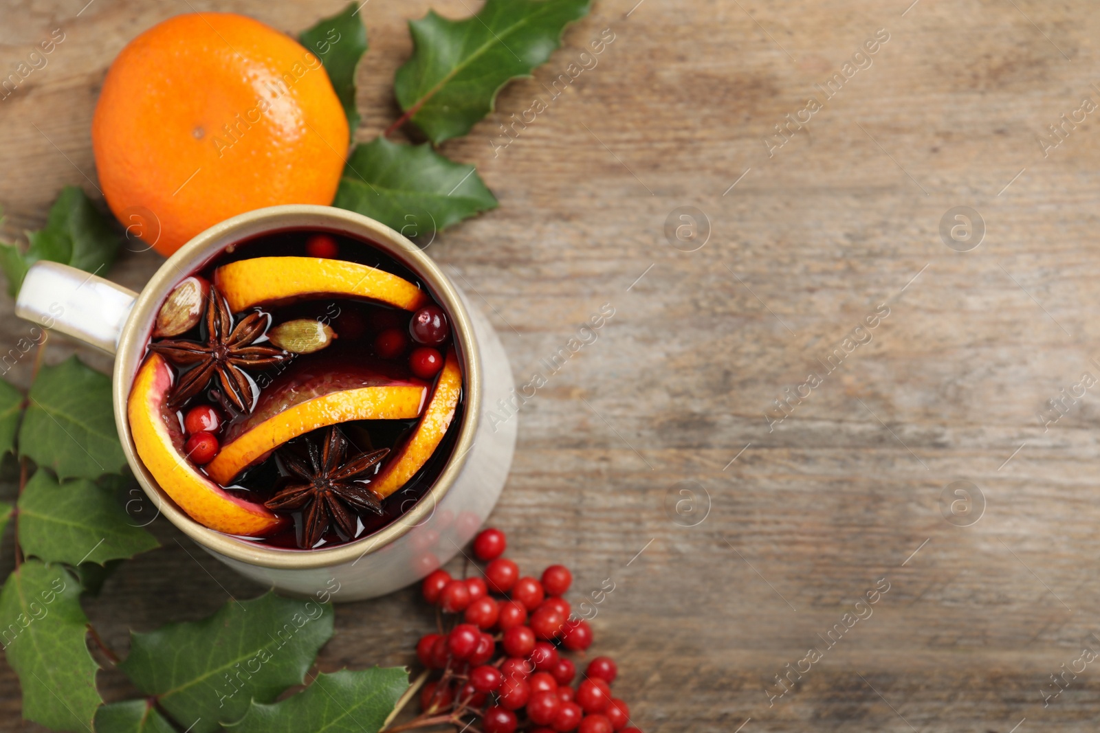 Photo of Composition with mulled wine on wooden table, space for text