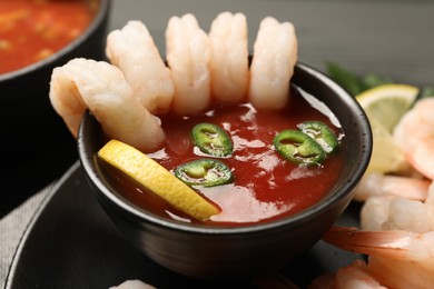 Photo of Tasty shrimp cocktail with sauce on table, closeup