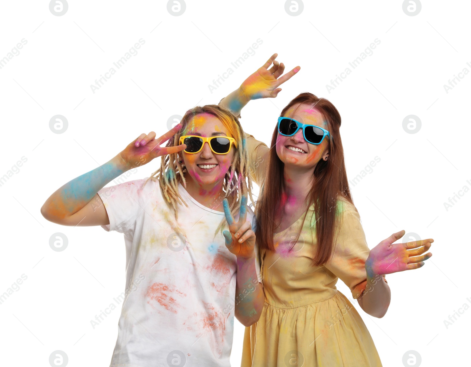 Photo of Women covered with colorful powder dyes on white background. Holi festival celebration