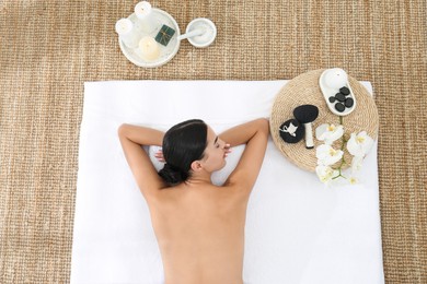 Young woman relaxing in spa salon, top view