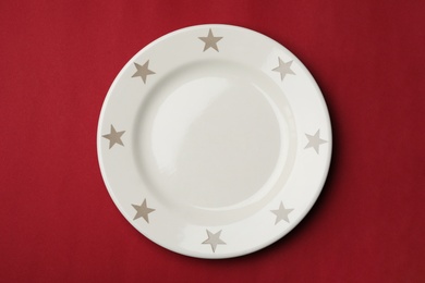 Clean empty plate on color background, top view