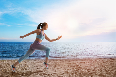 Image of Athletic young woman running near sea on sunny day, space for text 