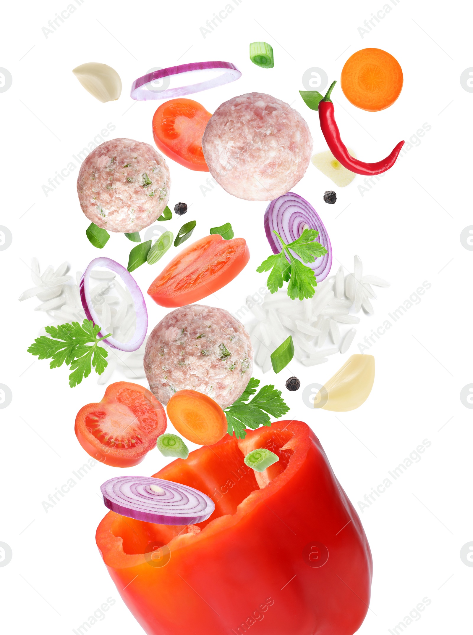 Image of Stuffed pepper recipe. Fresh ingredients falling into bell pepper on white background