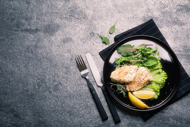 Image of Tasty grilled fish on grey table, flat lay with space for text. Food photography  