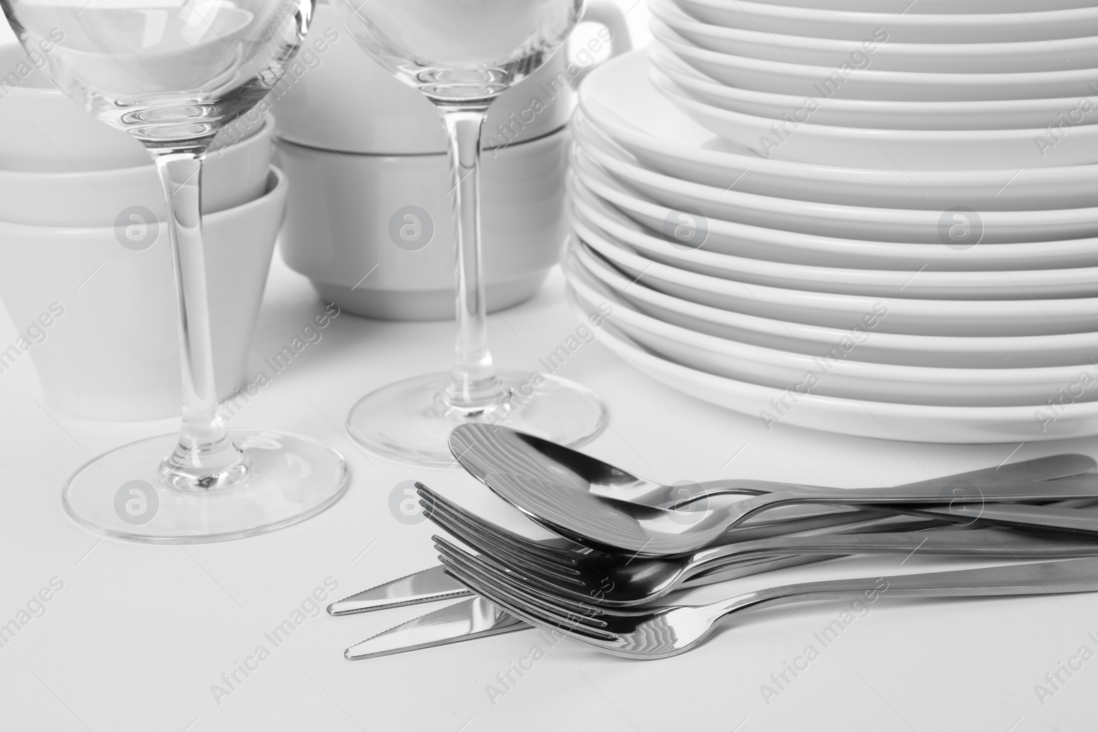 Photo of Set of clean tableware on white background, closeup. Washing dishes