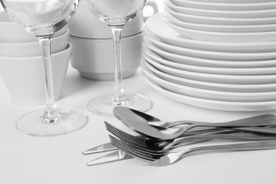 Photo of Set of clean tableware on white background, closeup. Washing dishes