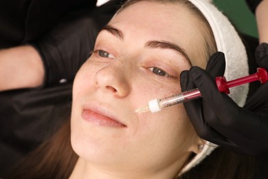 Cosmetologist giving facial injection to patient, closeup. Cosmetic surgery