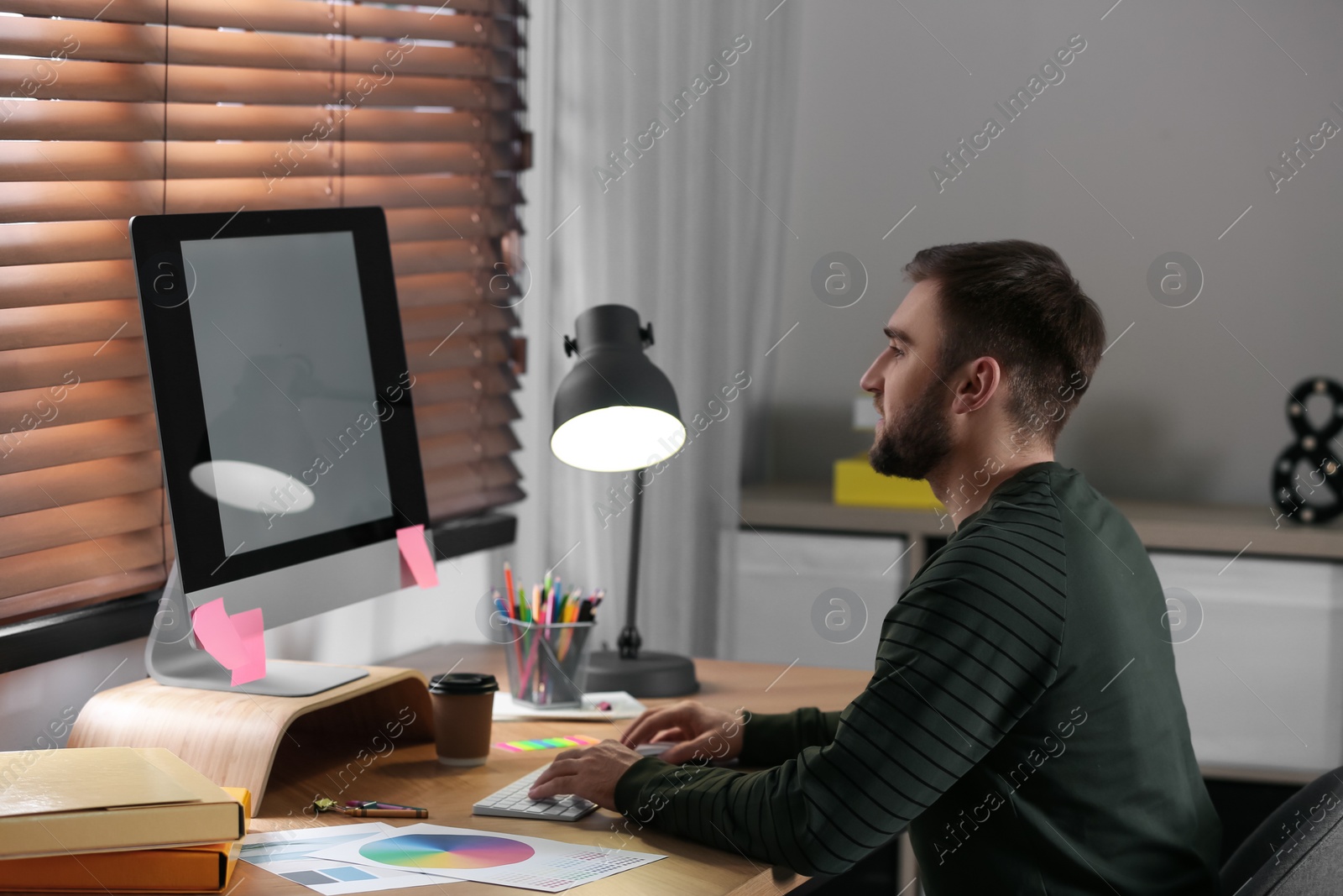 Photo of Male designer working at desk in office