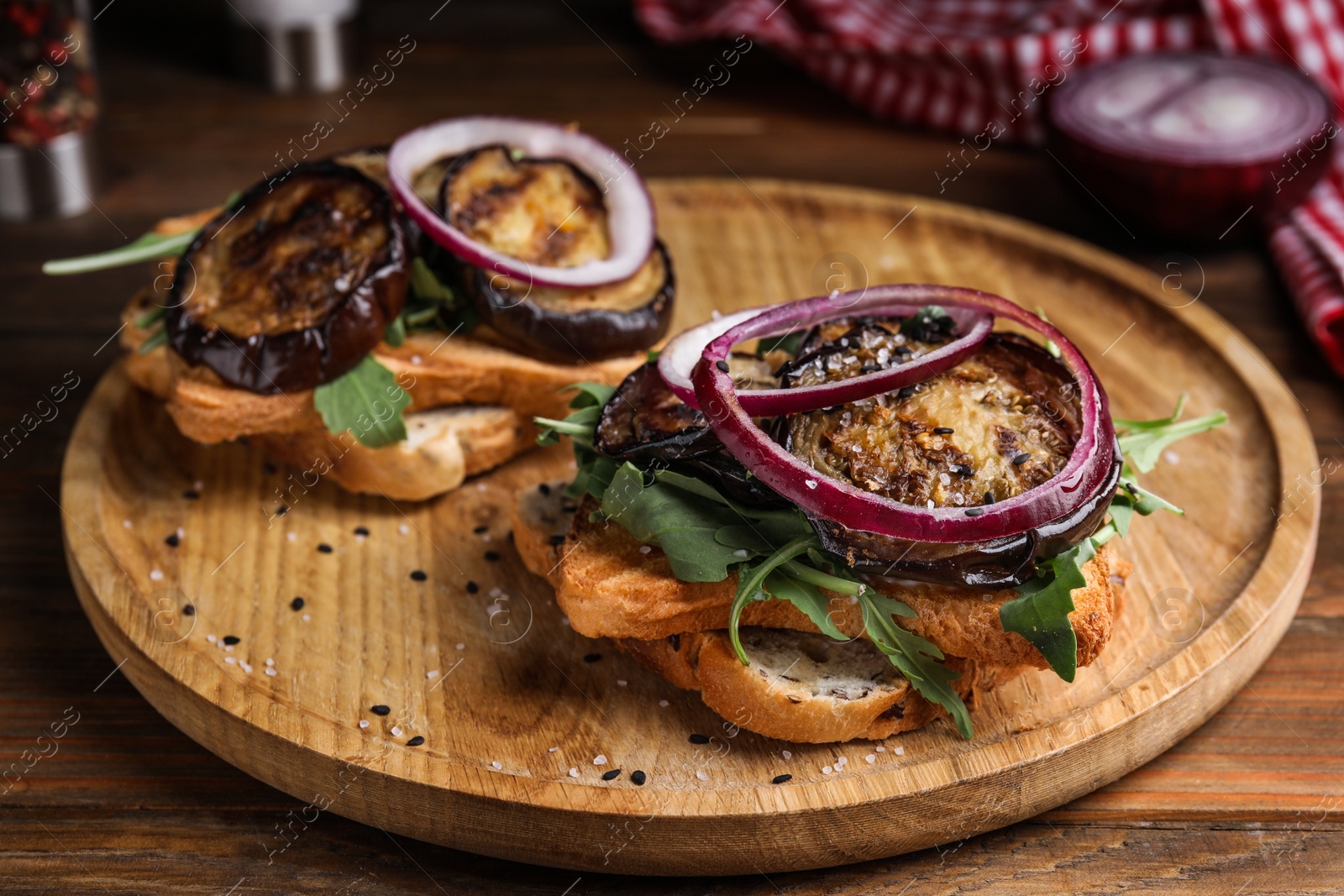 Photo of Delicious fresh eggplant sandwiches served on wooden table