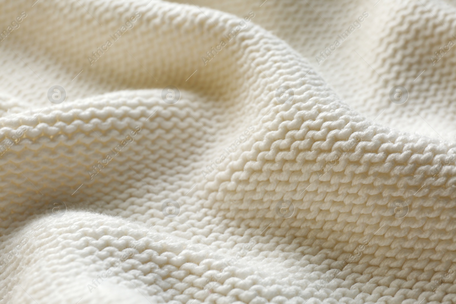 Photo of Beautiful white knitted fabric as background, closeup