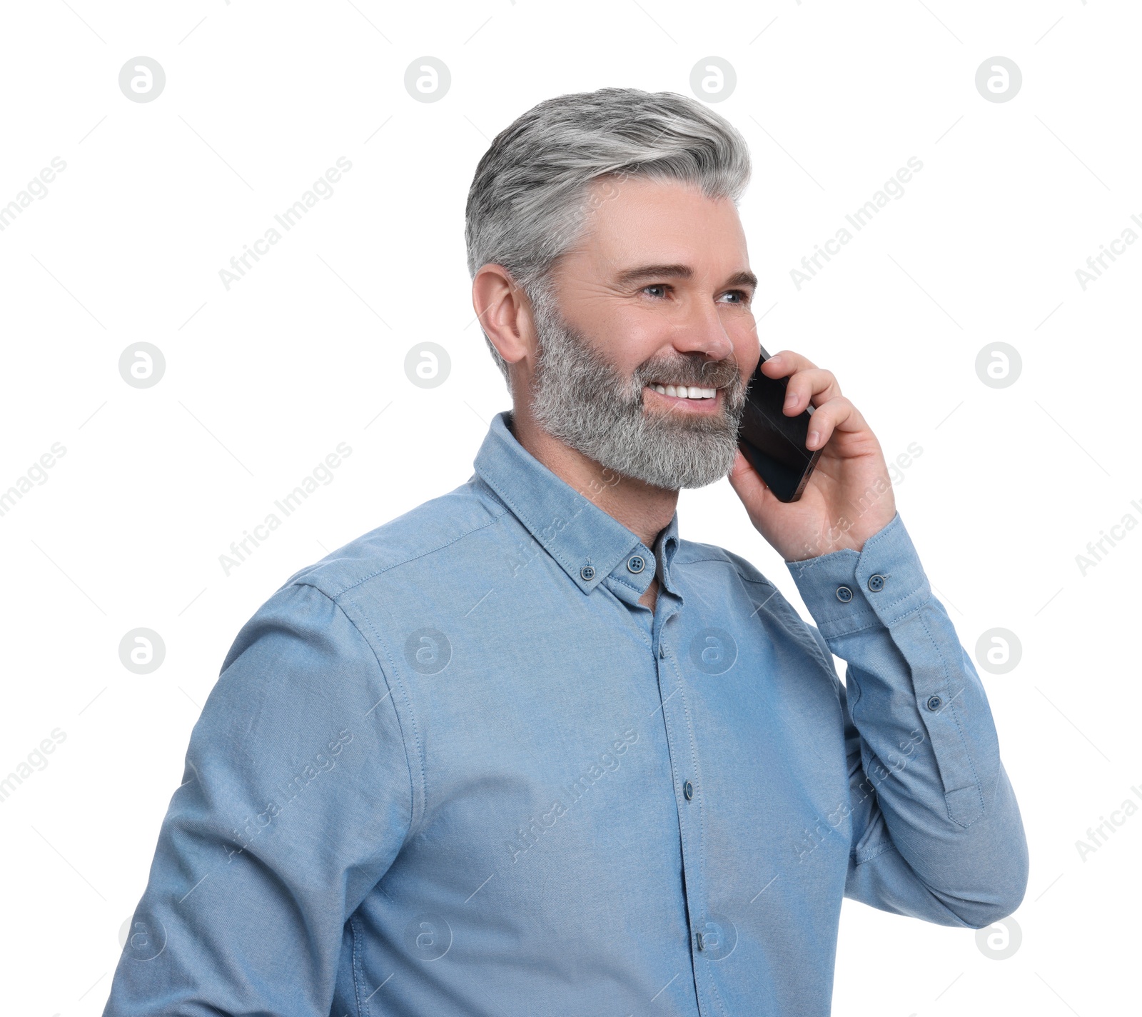 Photo of Mature businessman in stylish clothes talking on smartphone against white background