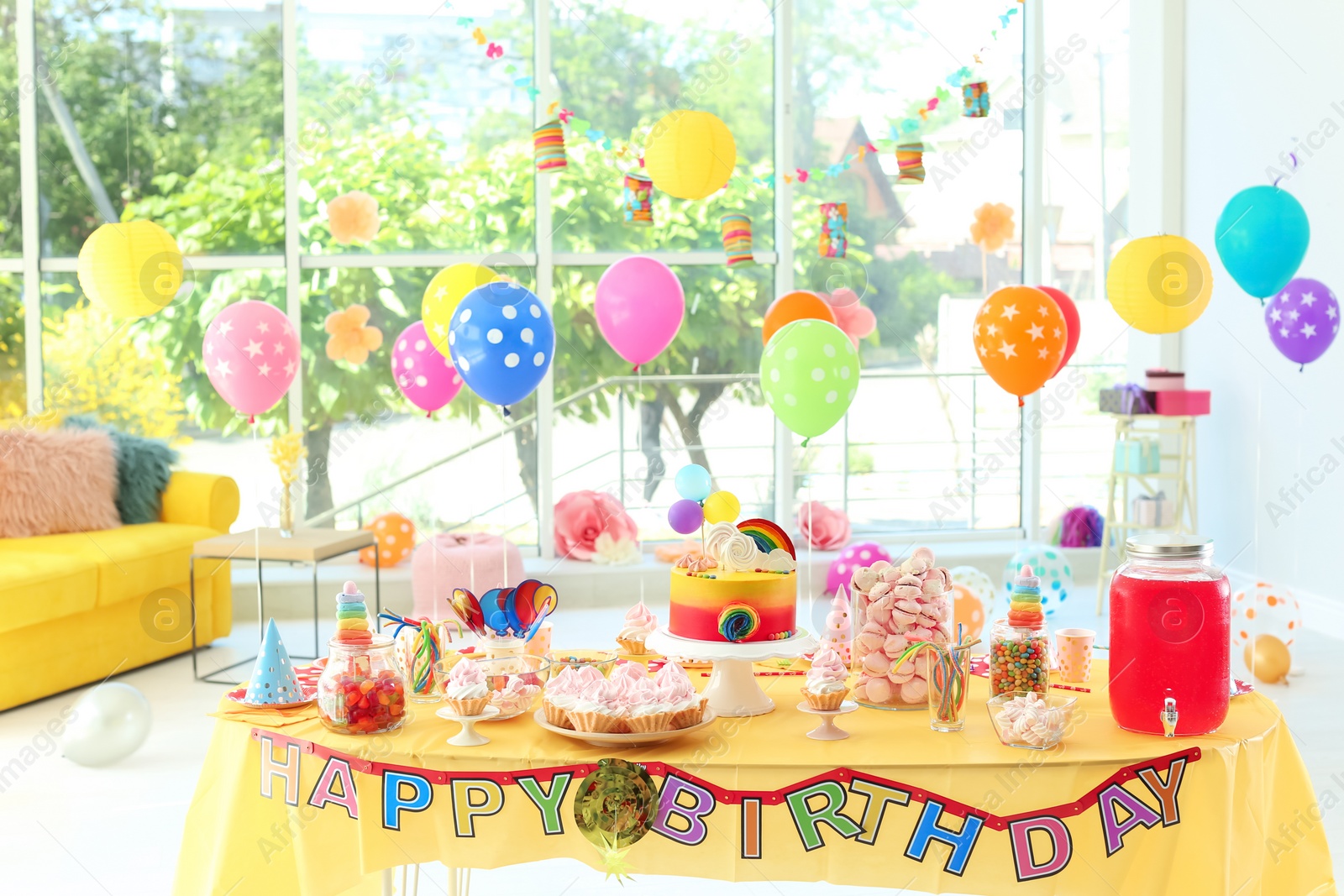 Photo of Table with birthday cake and delicious treats indoors