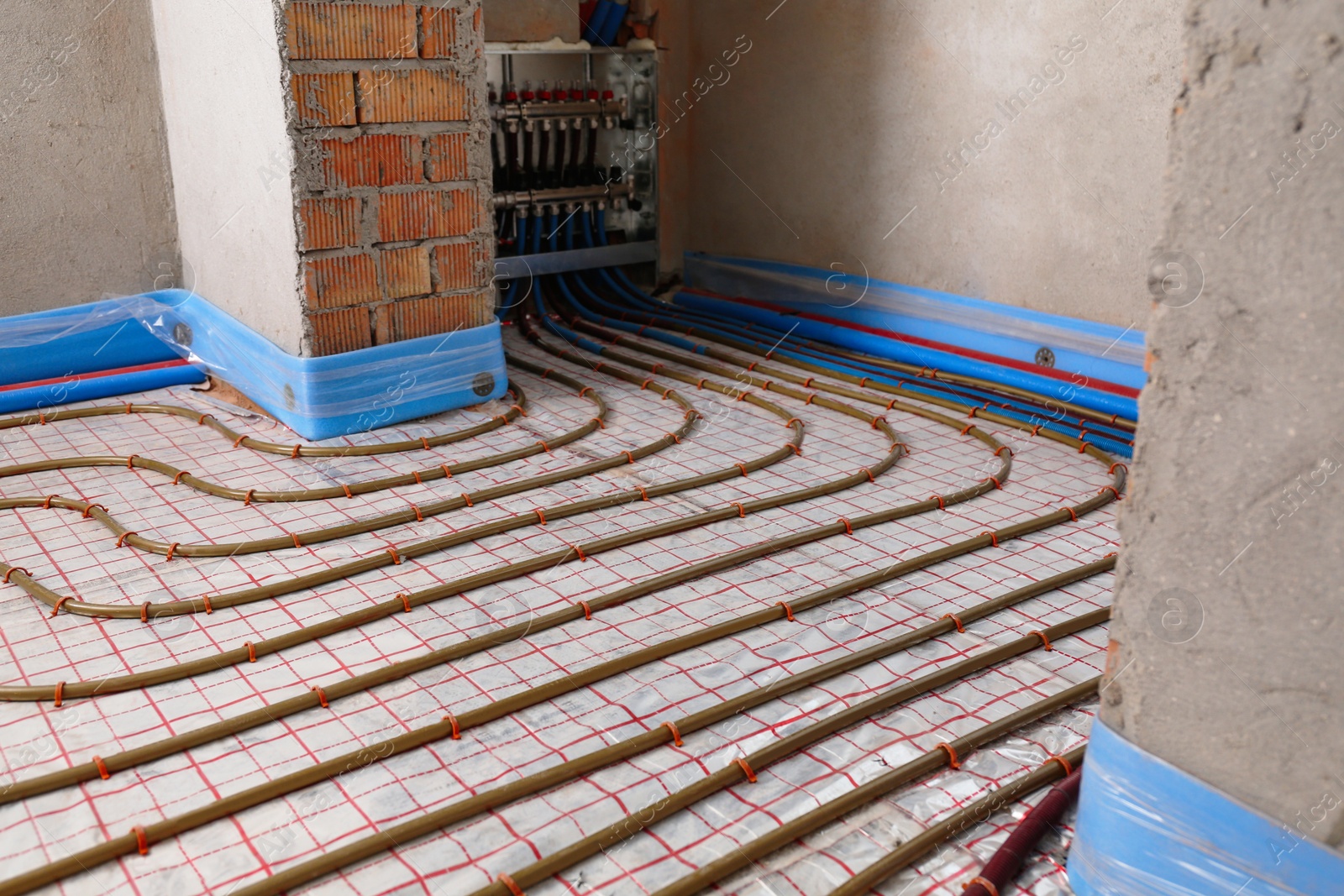 Photo of Installation of underfloor heating system in building