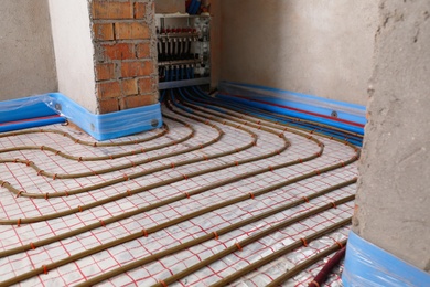 Photo of Installation of underfloor heating system in building