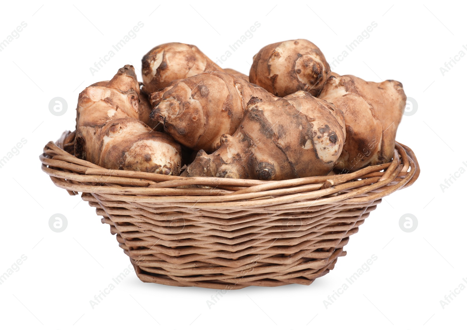 Photo of Wicker basket with many Jerusalem artichokes isolated on white