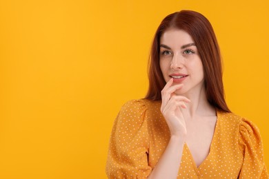 Photo of Portrait of beautiful woman with freckles on yellow background. Space for text