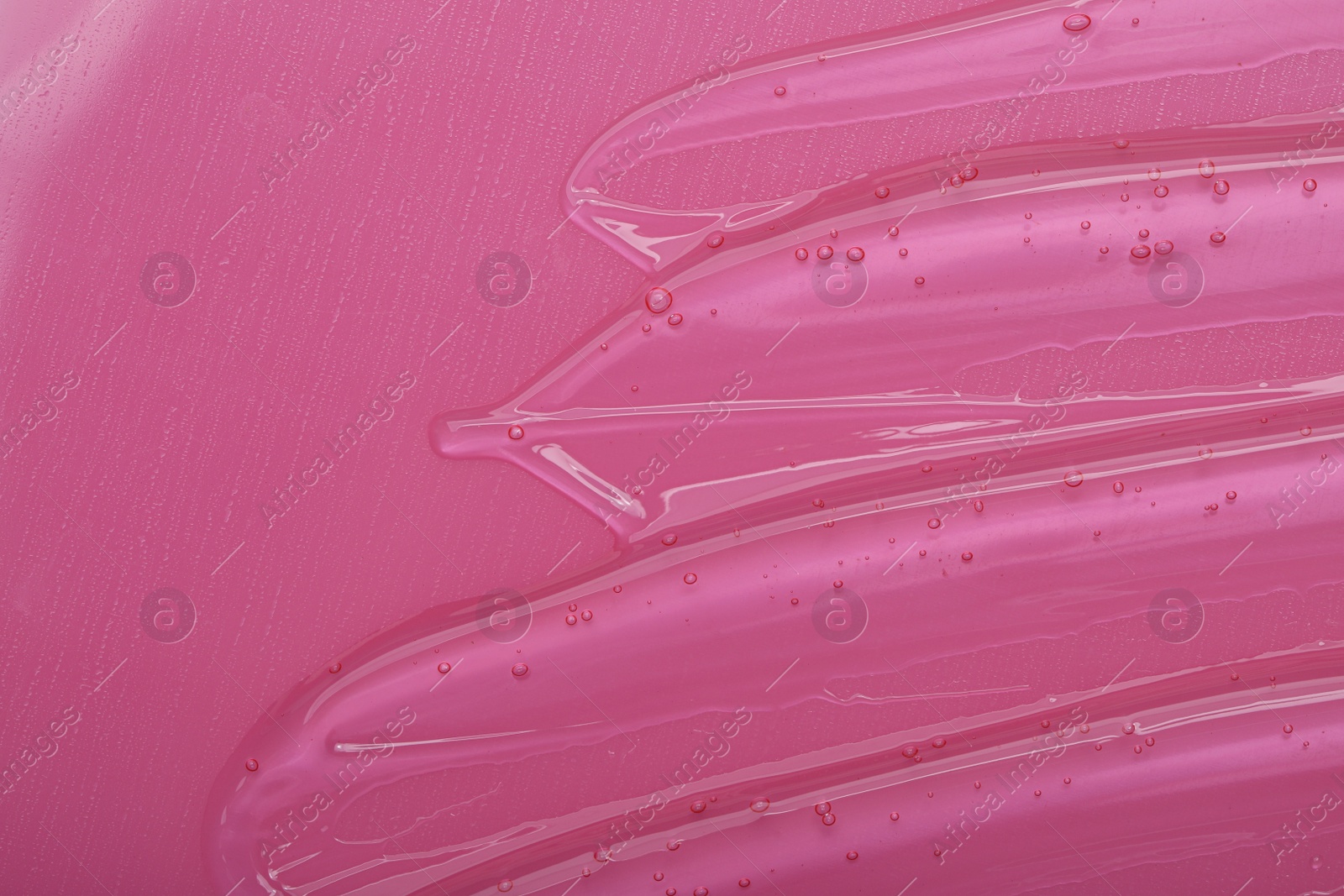 Photo of Pure transparent cosmetic gel on pink background, top view