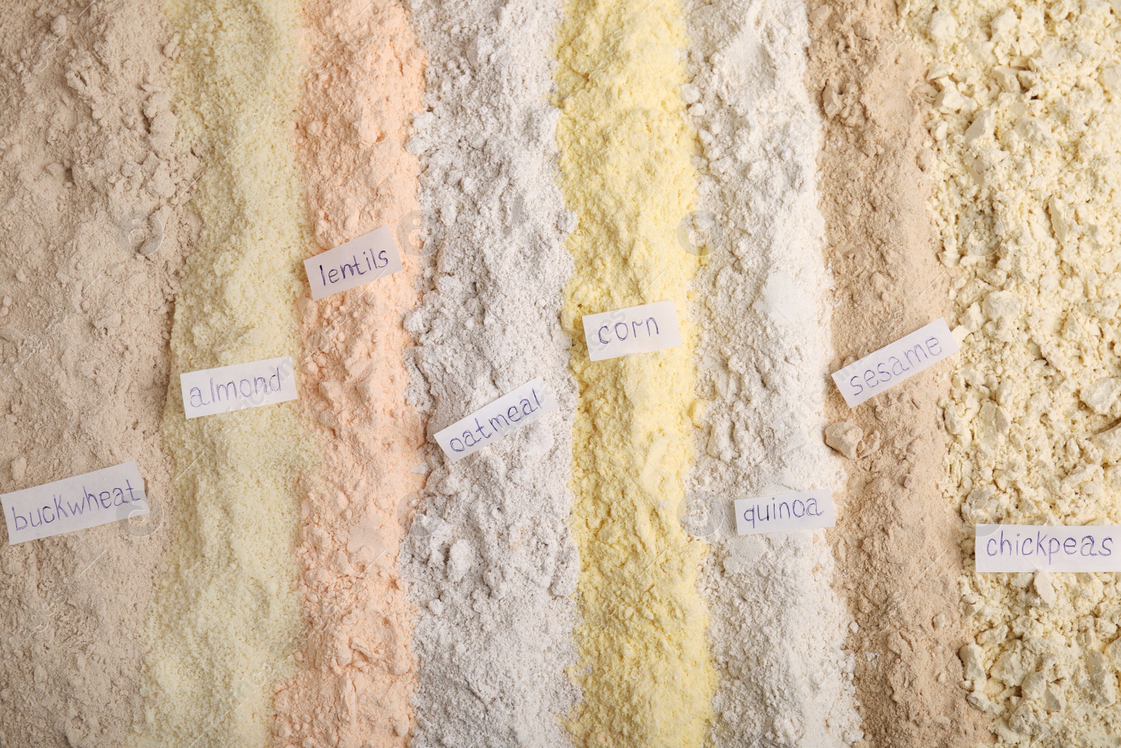 Photo of Different types of flours as background, top view