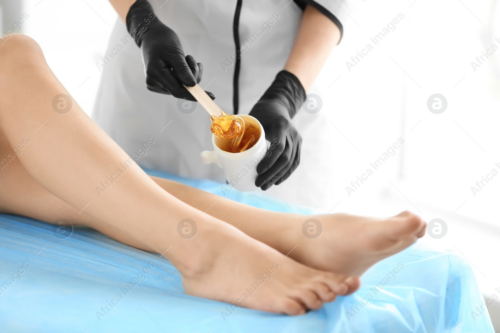 Photo of Woman getting wax epilation in salon