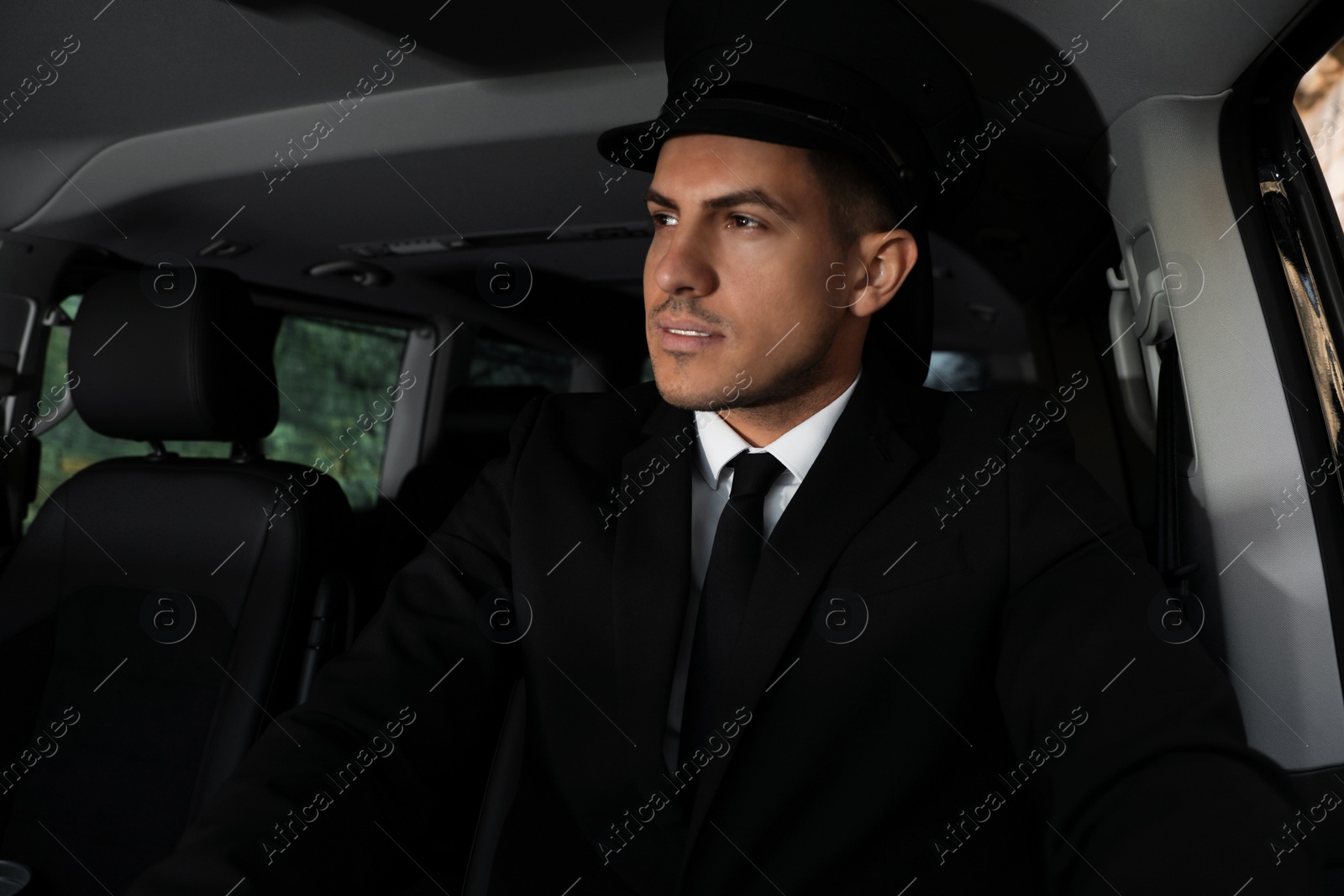 Photo of Professional driver in luxury car. Chauffeur service