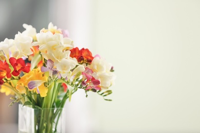 Photo of Beautiful bouquet of freesia flowers on blurred background