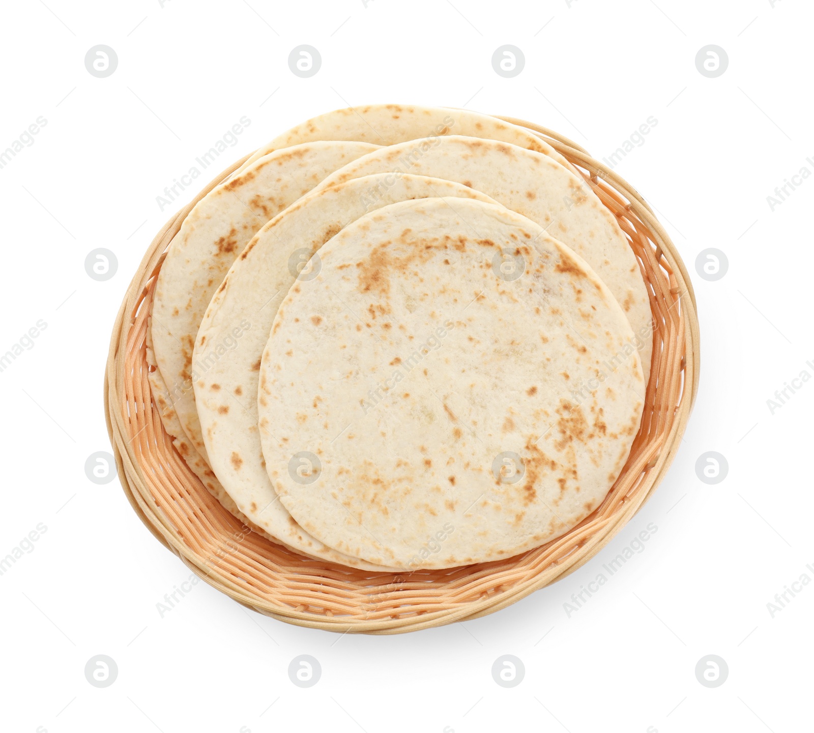 Photo of Tasty homemade tortillas in wicker basket isolated on white, top view