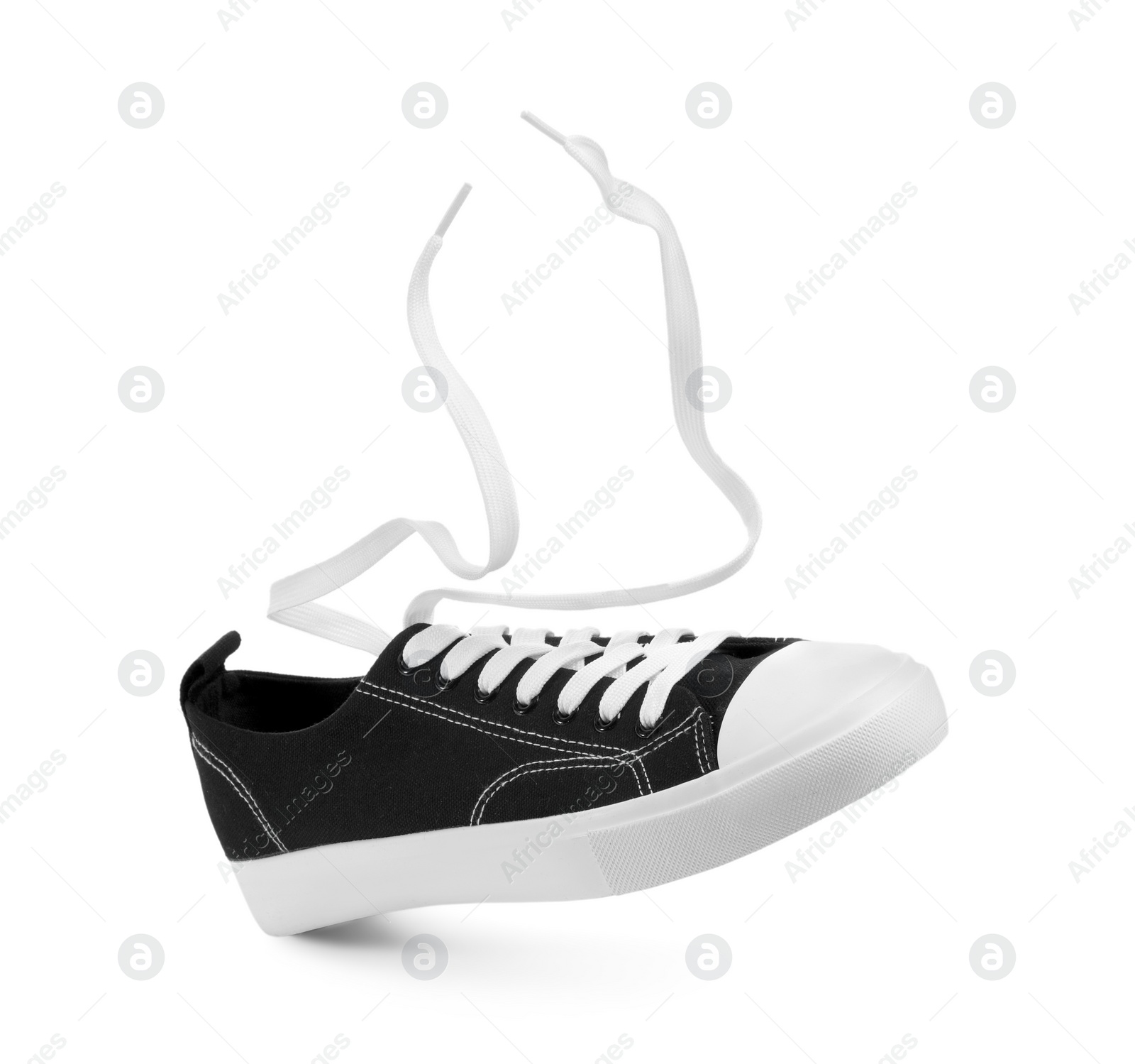 Photo of One black classic old school sneaker isolated on white