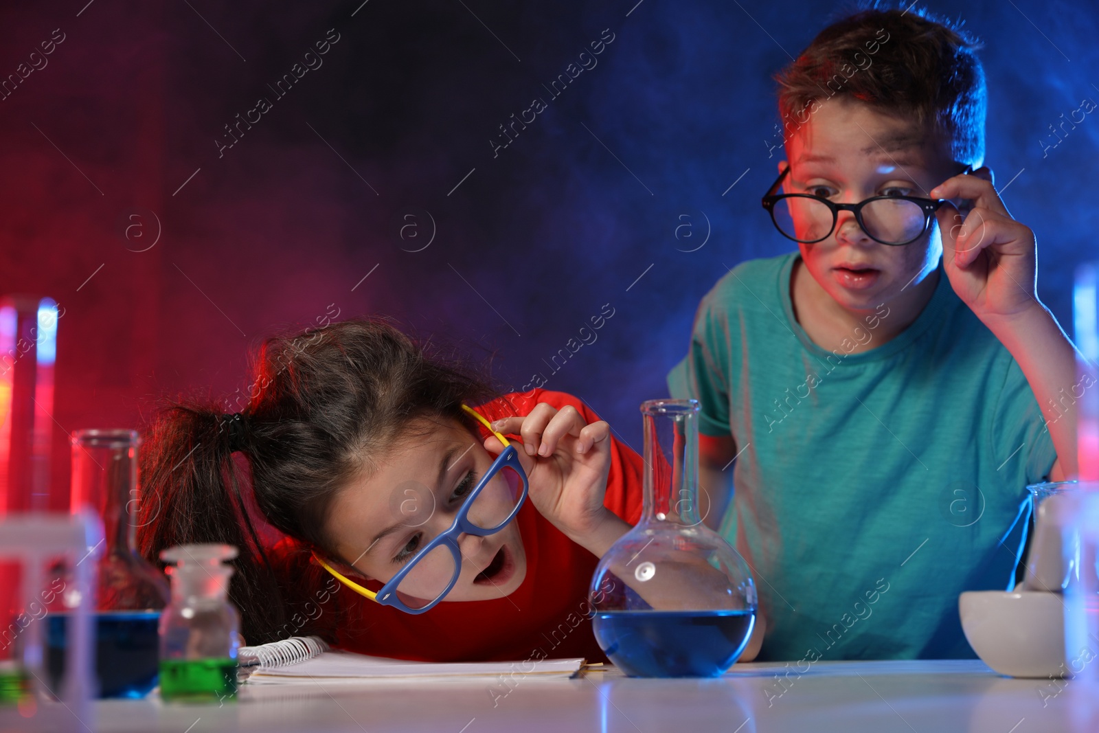 Photo of Children doing chemical research in laboratory. Dangerous experiment