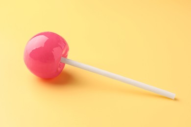 One tasty lollipop on yellow background, closeup