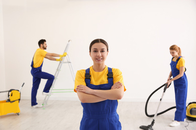 Photo of Professional janitor in uniform indoors. Cleaning service