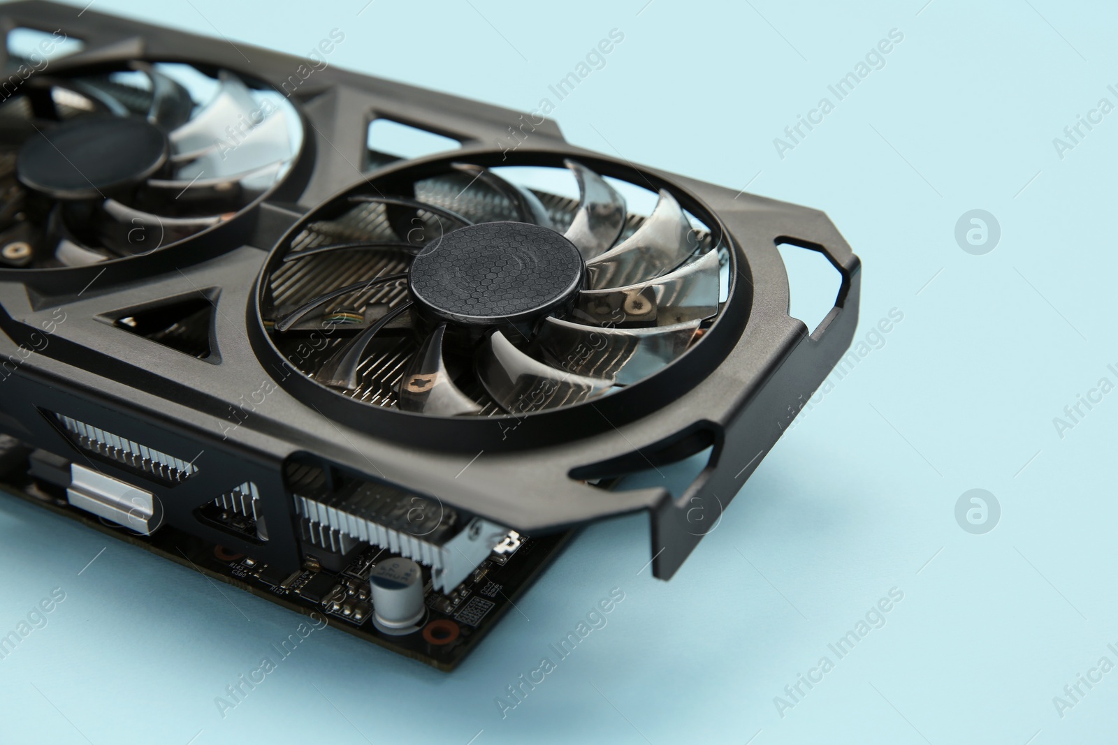 Photo of One graphics card on light blue background, closeup